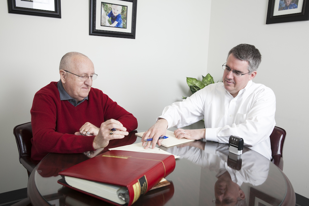 Attorney explaining the difference between estate planning and life insurance to a client.